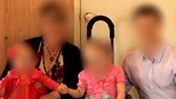A mother has been arrested and is now under police guard in hospital after she and her three children were found with stab wounds