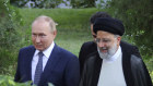 Russian President Vladimir Putin, left, and his Iranian counterpart Ebrahim Raisi walk at the presidency palace in Tehran.