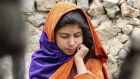 An Afghan girl stands near a house that was damaged by an earthquake in the Spera District of the south-western part of Khost Province, Afghanistan.