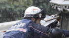 Firefighters look for survivors in Suzu, Ishikawa prefecture, on Sunday.
