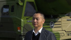 Visitors at a display of Chinese military vehicles with ballistic missiles at an exhibition to ahead of the 20th Party Congress in Beijing. 