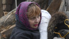 Local residents carry their belongings as they leave their home ruined in Russian rocket attack in Zaporizhzhya.