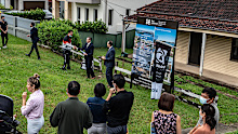 Crowds peer at an auction for the sale of a residence in the Sydney suburb of Putney on March 26, 2022.