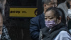 Garment factory workers show samples of their work looking for clients in Guangzhou, China. 