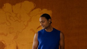 Designer Brahman Perera in front of his ‘Temple Silhouette’ carpet for Ruggable.