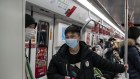 Commuters ride a subway train in Shanghai. China is experiencing an increase in COVID-19-related deaths, but they are not being reported in official government figures.