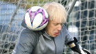 Britain's Prime Minister Boris Johnson stands in goal prior to a  Juniors girls soccer match between Hazel Grove United JFC and Poynton, as he campaigns in Cheadle Hulme, England, Saturday, Dec. 7, 2019. 