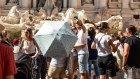 Tourists swarm the Trevi Fountain in Rome in July. 