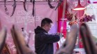 Shoppers browse through an open air food market in Shanghai. Consumer sentiment has been weak. 
