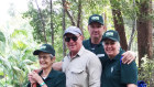 Fun Over Fifty customers planting trees with a Fraser Island ranger as part of a tour. 