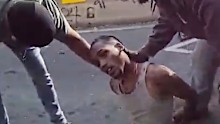In this image taken from police-worn body camera video released the New York City Police Department (NYPD), law enforcement personnel tend to a Oscar Belgal, 28, a Dominican man who was shot by Federal immigration officers,, as he drove his car with a five-year-old boy inside.