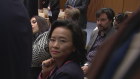 Australian journalist Cheng Lei is “flanked” by two Chinese government officials during a signing ceremony at Parliament House on Monday.