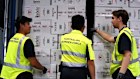 Australian Border Force officers with a container of illegal cigarettes.