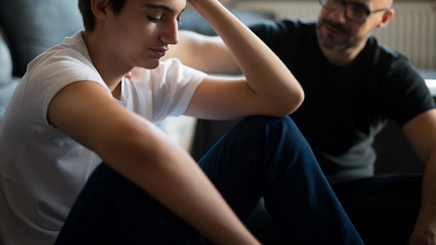 Upset young man talking with his father.