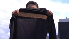 Daniel Arzani holds a shirt with Mahsa Amini's name on it to support Iranian women's rights.