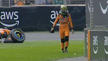 Oscar Piastri walks away after the crash.