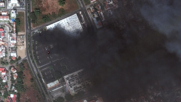 Smoke rises from cars on fire at a Costco parking lot in Puerto Vallarta, Mexico, as violence breaks out after the Mexican army killed the leader of the Jalisco New Generation Cartel, Nemesio Rubén Oseguera Cervantes, known as "El Mencho".