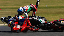 Jack Miller slides while Alex Marquez flies through the air after contact at Miller Corner.