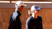 Rafael Nadal speaks with Iga Swiatek during a training session.