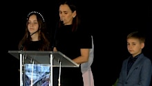 Paul Green's wife, Amanda, speaks at his memorial service alongside their children, Emerson and Jed.