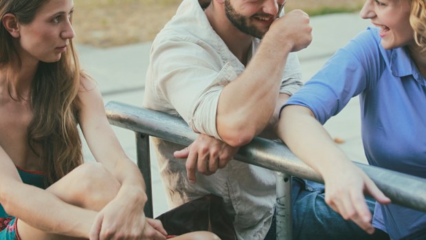 Jelaous friend looking at happy couple. Women. Three friends