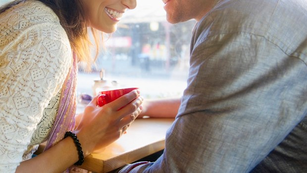 Couple holding hands in cafe