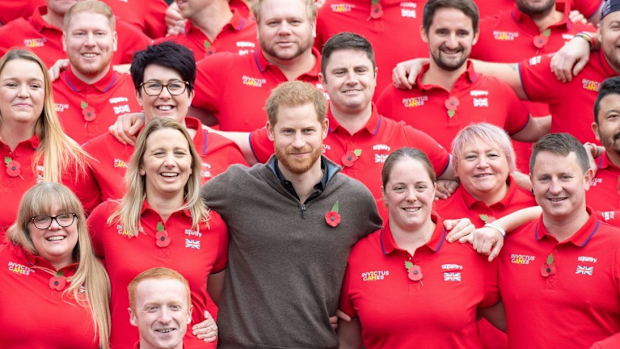 Prince Harry poses with Invictus volunteers during an event in June.