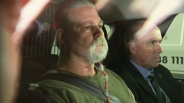 The man arrested and charged with the murder of Linda Reed is transported by police.