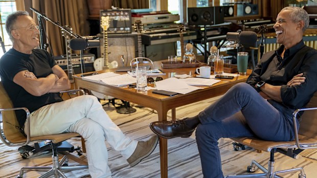 Bruce Springsteen, left, appears with former President Barack Obama during their podcast of conversations recorded at Springsteen's home studio in New Jersey. The eight-episode series covers their upbringings, racism, fatherhood and even recall a White House singalong around a piano.