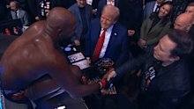 Jon Jones shakes hands with Donald Trump and Elon Musk.