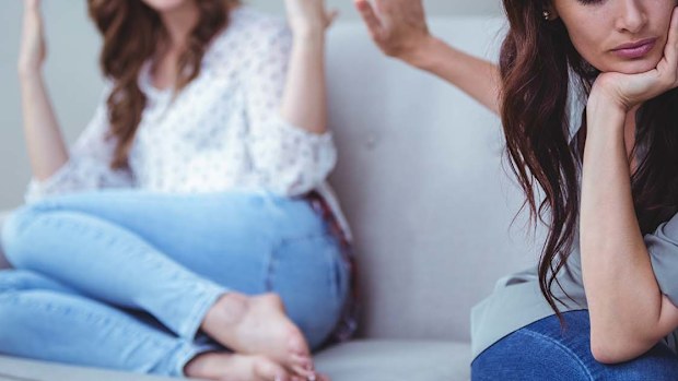 Two women sitting on the couch in the middle of an argument.