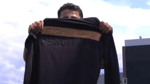 Daniel Arzani holds a shirt with Mahsa Amini's name on it to support Iranian women's rights.