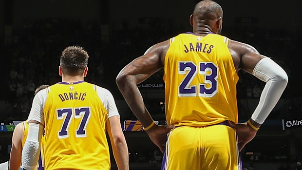 Luka Doncic #77 and LeBron James #23 of the Los Angeles Lakers looks on during the game against the Minnesota Timberwolves   during Round 1 Game 3 of the 2025 NBA Playoffs  on April 25, 2025 at Target Center in Minneapolis, Minnesota. NOTE TO USER: User expressly acknowledges and agrees that, by downloading and or using this Photograph, user is consenting to the terms and conditions of the Getty Images License Agreement. Mandatory Copyright Notice: Copyright 2025 N