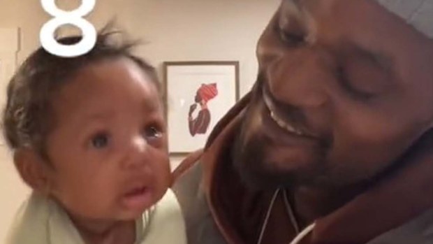 Dad holding baby to make him stop crying.