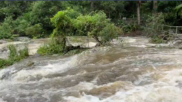 Cascading water is seen in the Gympie region, amid fears the city could be split in two if more rain falls.