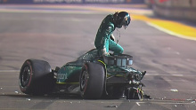 Lance Stroll climbing from what's left of his Aston Martin after a massive crash at the end of the first part of qualifying for the Singapore Grand Prix.