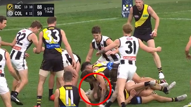 Collingwood's Jack Ginnivan is pushed in the head by Richmond's Rhyan Mansell.