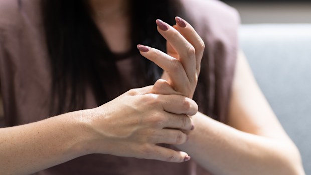Woman cracking knuckles.