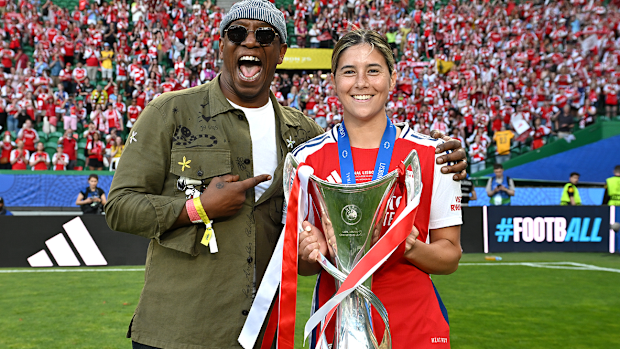 Former Arsenal footballer Ian Wright celebrates the club's UEFA Women's Champions League win with Australia's Kyra Cooney-Cross.