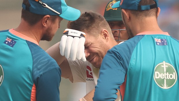 David Warner of Australia has his elbow looked at by medical staff after he was struck by a ball from Mohammed Siraj of India during day one of the Second Test match in the series between India and Australia at Arun Jaitley Stadium on February 17, 2023 in Delhi, India. (Photo by Robert Cianflone/Getty Images)