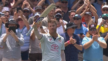 David Warner acknowledges the crowd as he walks off the SCG.