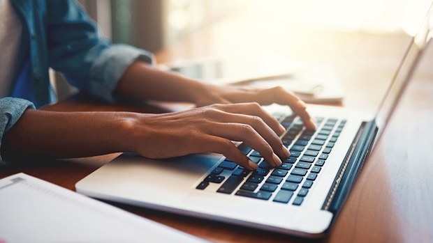 woman typing on laptop. 