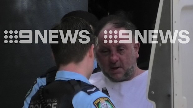 The 60-year-old father who randomly fired up to 50 shots from his unit window in Sydney's inner west has been captured leaving a hospital on his way to the police station, where he awaits charges. 