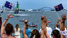 Spectators on Shark Island cheer as Australia's SailGP team, helmed by Tom Slingsby, crosses the finish line to win on Race Day 1 of the KPMG Australia Sail Grand Prix in Sydney, Australia. Saturday 8 February 2025. Rolex SailGP Championship Event 3 Season 2025. Photo: Patrick Hamilton for SailGP. Handout image supplied by SailGP