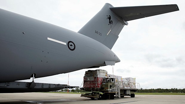 Air Force Air Movements Operators from No. 23 Squadron load humantarian assistance supplies bound for Tonga onto a C-17A Globemaster III strategic transport aircraft at RAAF Base Amberley.