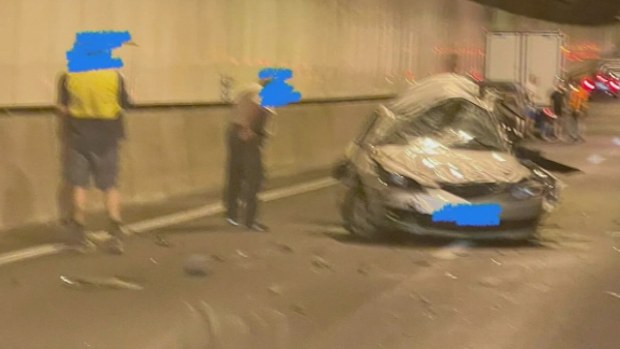 Two people have died and two others have been hospitalised after a three-vehicle crash in a major Brisbane tunnel.