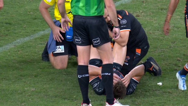 Wests Tigers hooker Jake Simpkin leaves the field injured.