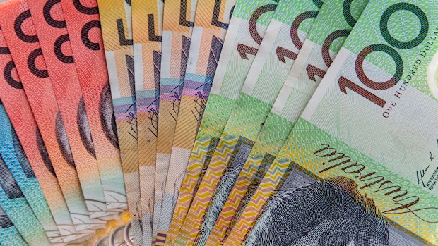 hand holding assortment of Australian cash notes