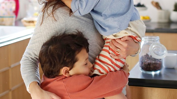 Woman hugging children