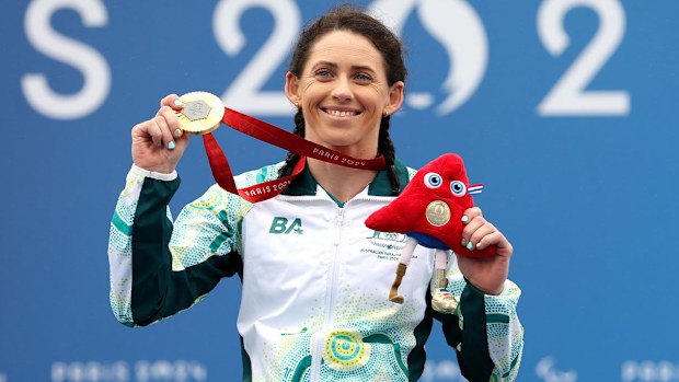 Lauren Parker gleams with pride after winning cycling gold.